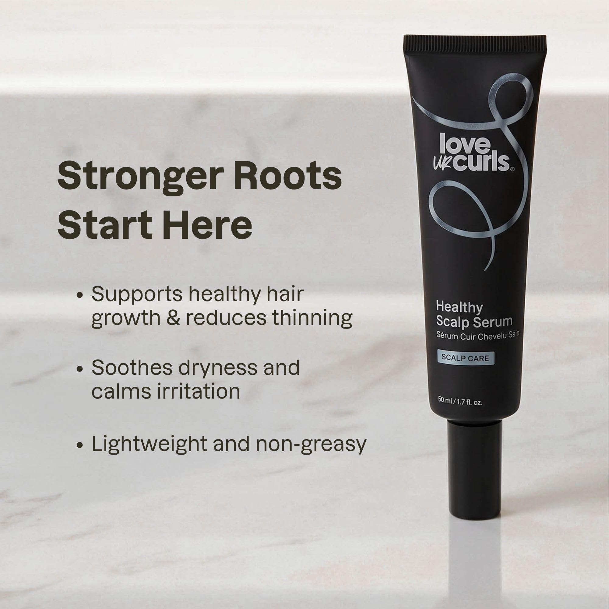 Love Ur Curls applying serum to scalp to show targeted use benefit