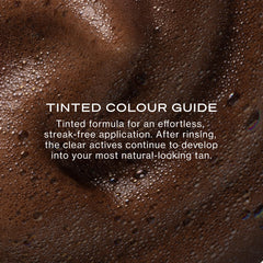 Loving Tan applicator mitt applying mousse for streak-free coverage
