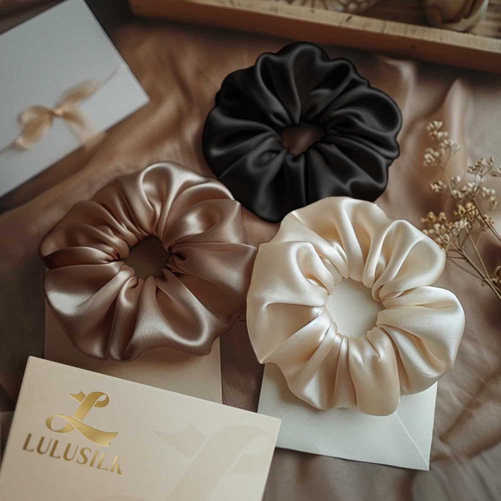 LULUSILK scrunchies beside bed in lifestyle scene suggesting nighttime hair care luxury