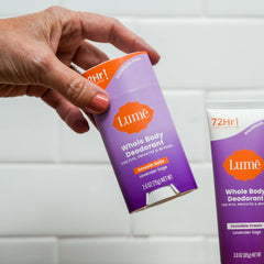 Lume stick being applied underarm for targeted odor control and comfort
