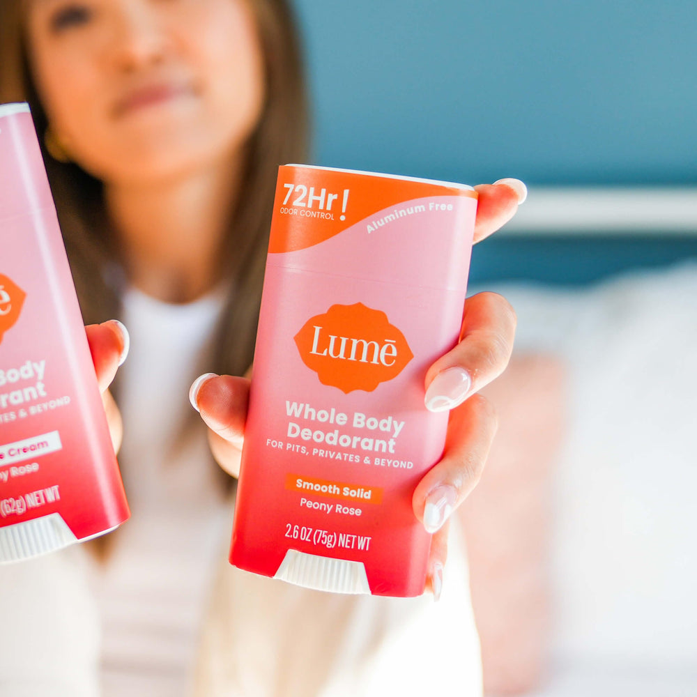 Lume deodorant stick in hand to show real-life scale and usage