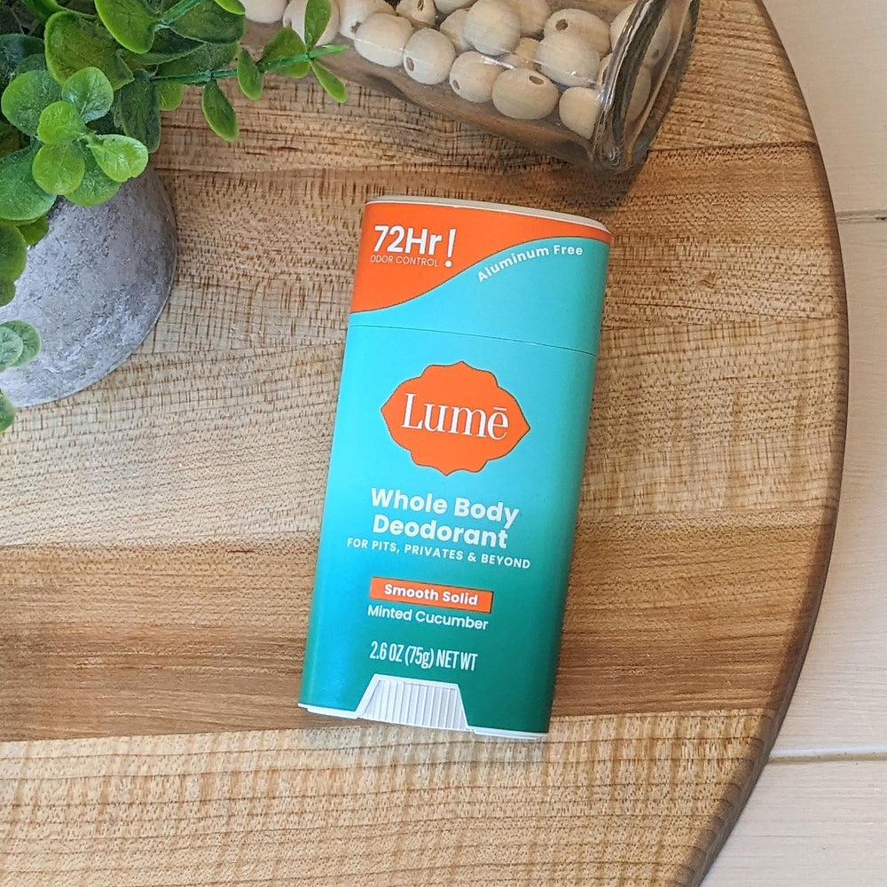 Lume stick held in hand for scale indicating compact, travel-friendly size