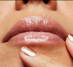 MAC Lipglass worn on lips in lifestyle setting for luminous shine