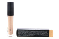 MAC Lipglass swatch on forearm demonstrates sheer peachy-nude color and shine