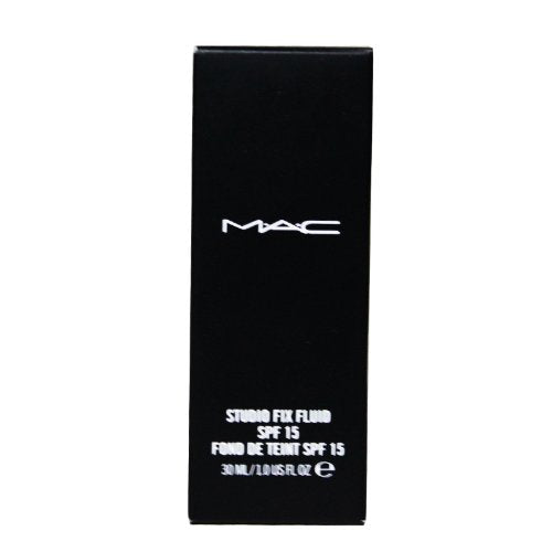 Hand holding M.A.C Studio Fix bottle to show size and scale for travel-friendly use