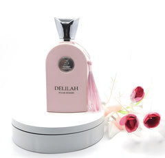 Maison Alhambra Delilah beside common items to show 3.4 oz scale and travel convenience