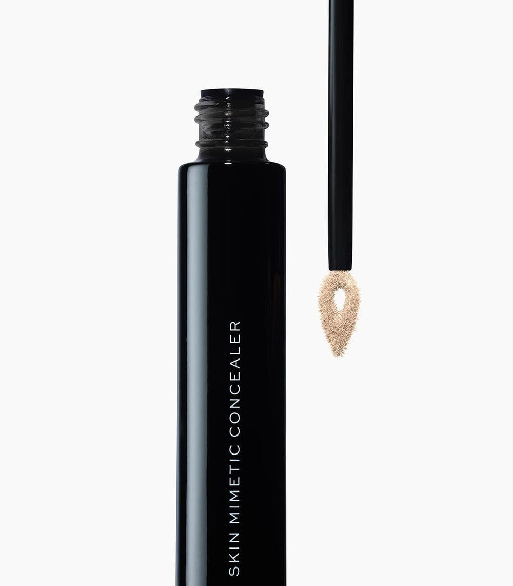 MAKE concealer drops on skin for scale showing lightweight, blendable finish