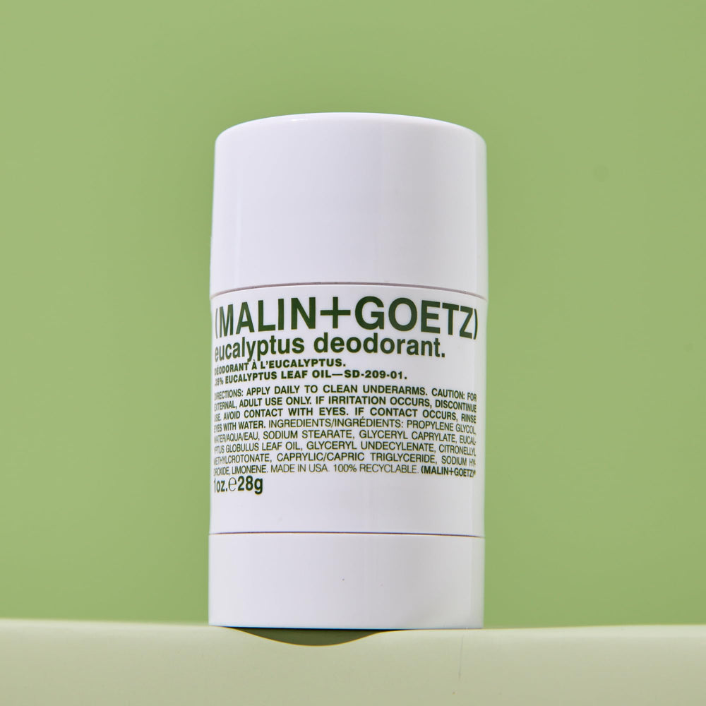 MALIN+GOETZ deodorant held in hand demonstrating compact design and quick use