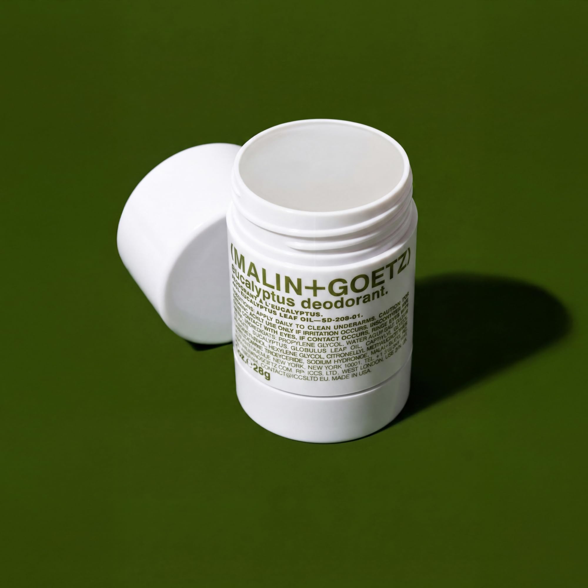 MALIN+GOETZ deodorant placed with toiletries flatlay suggesting daily routine ease