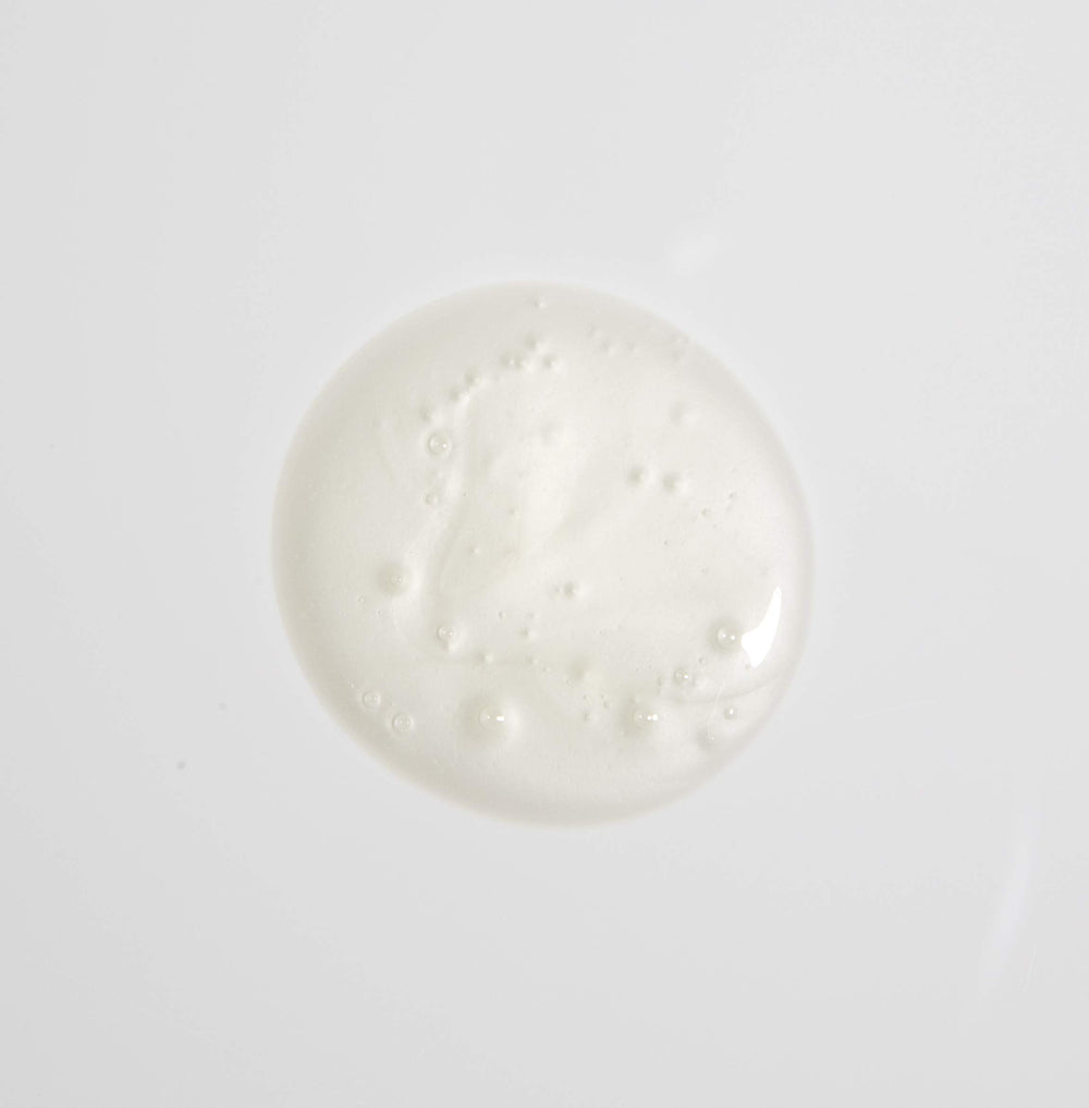 MALIN+GOETZ shampoo in hand being applied to hair showing easy dispense and gentle cleanse