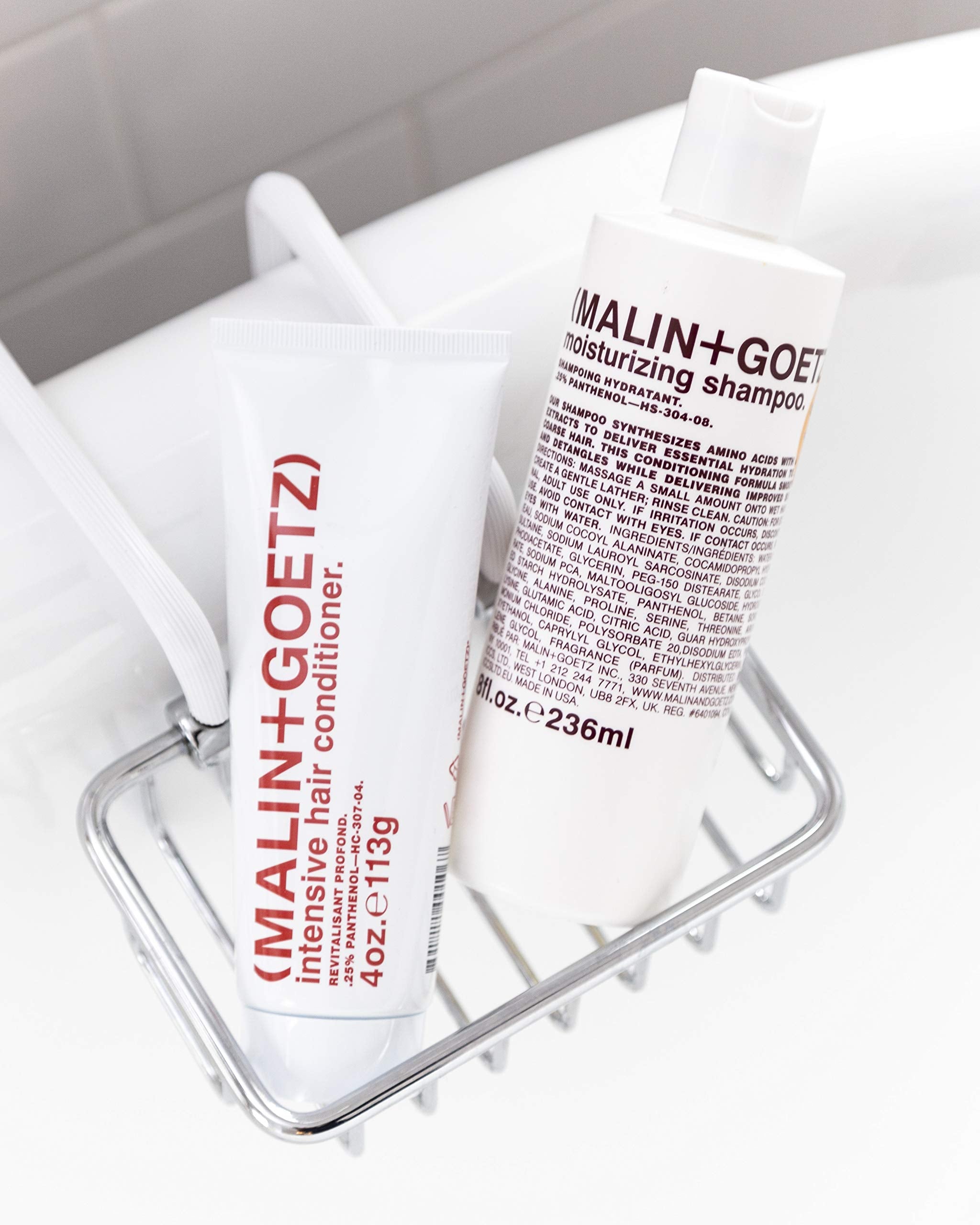 MALIN+GOETZ bottle next to measuring cup indicating 8 fl oz size and travel convenience