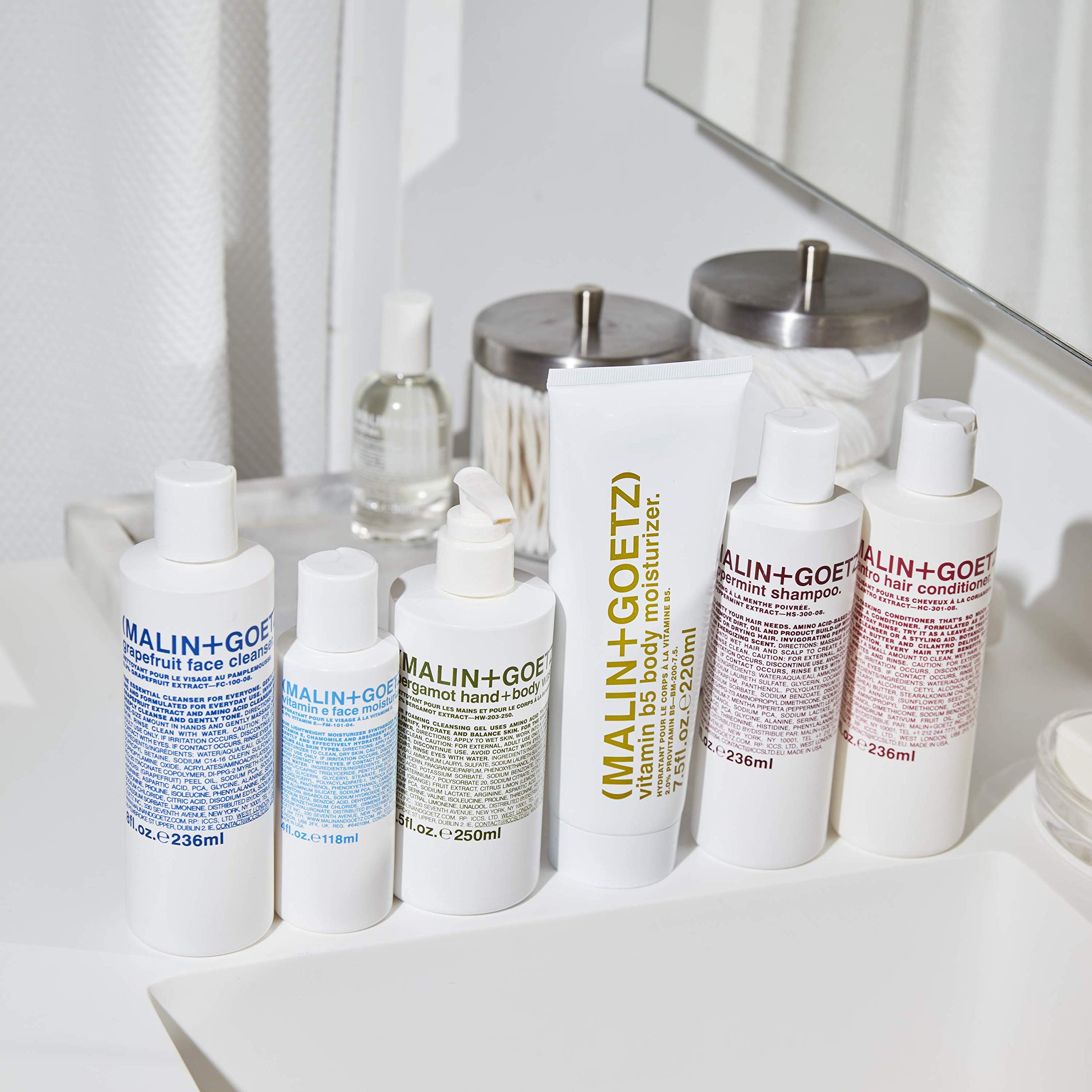 Unisex person using MALIN+GOETZ cleanser in morning routine showing balanced results