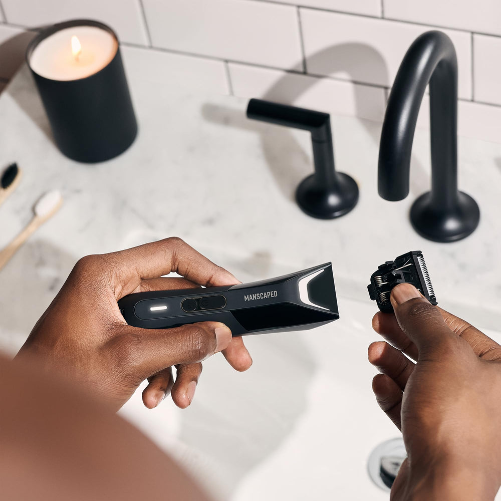 MANSCAPED held in hand for scale to show compact, ergonomic sizing