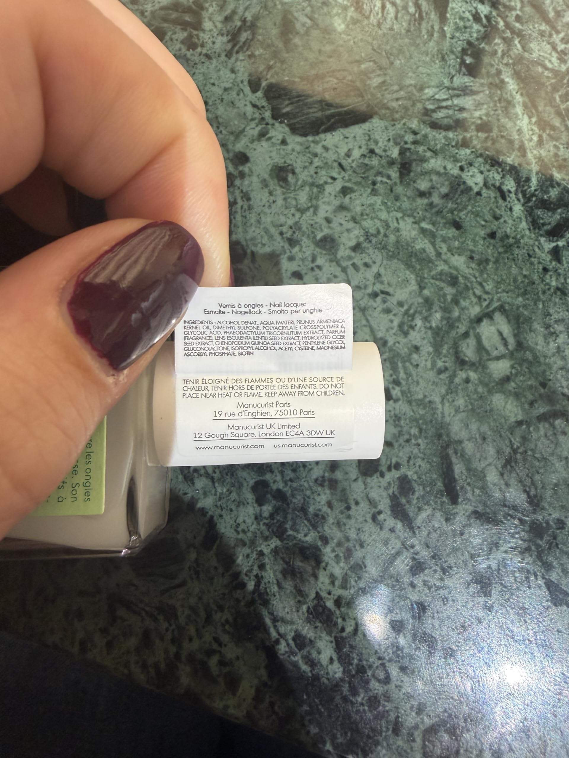 Manucurist bottle next to coin showing compact travel-friendly benefit