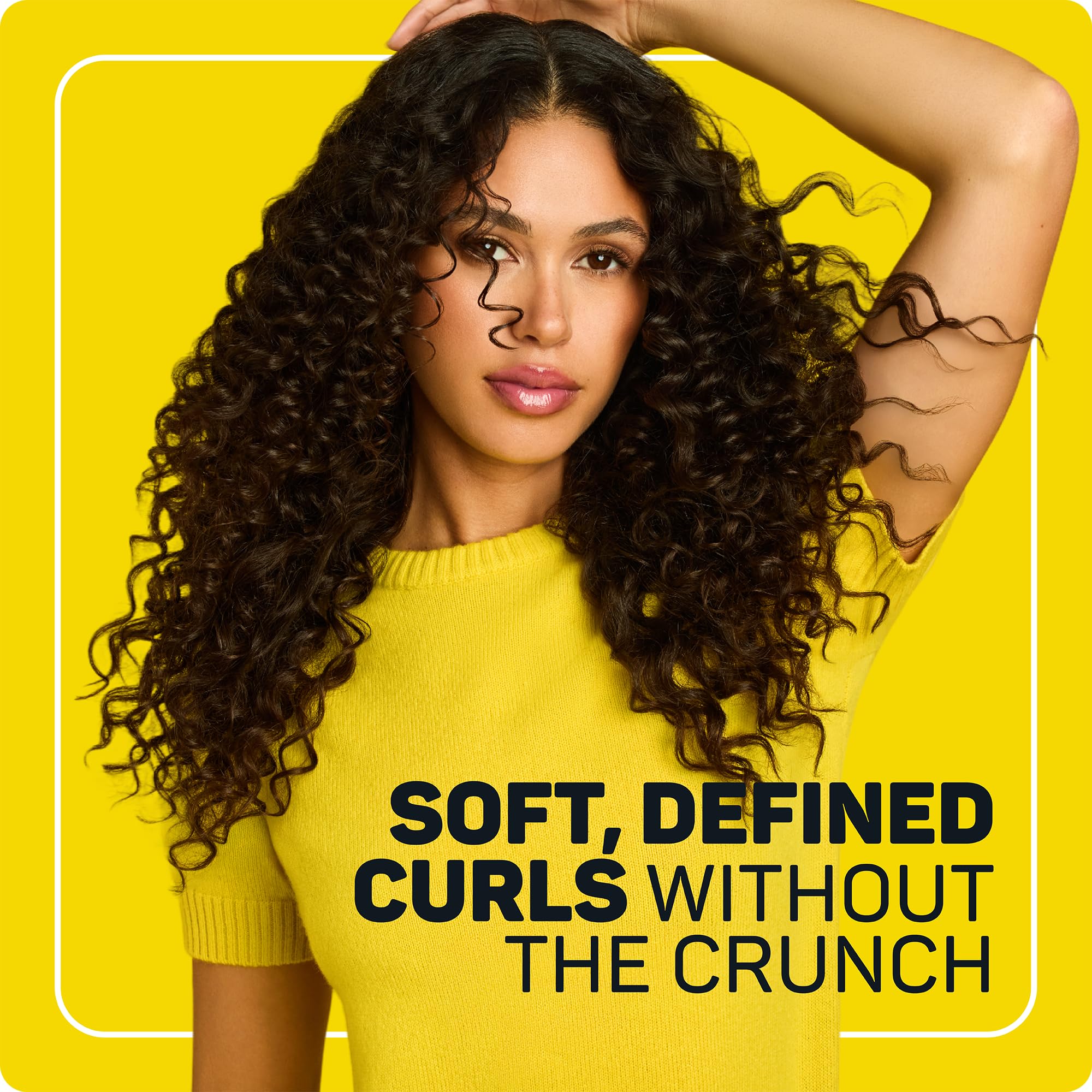 Marc Anthony applying cream to wet hair to reduce frizz and define curls