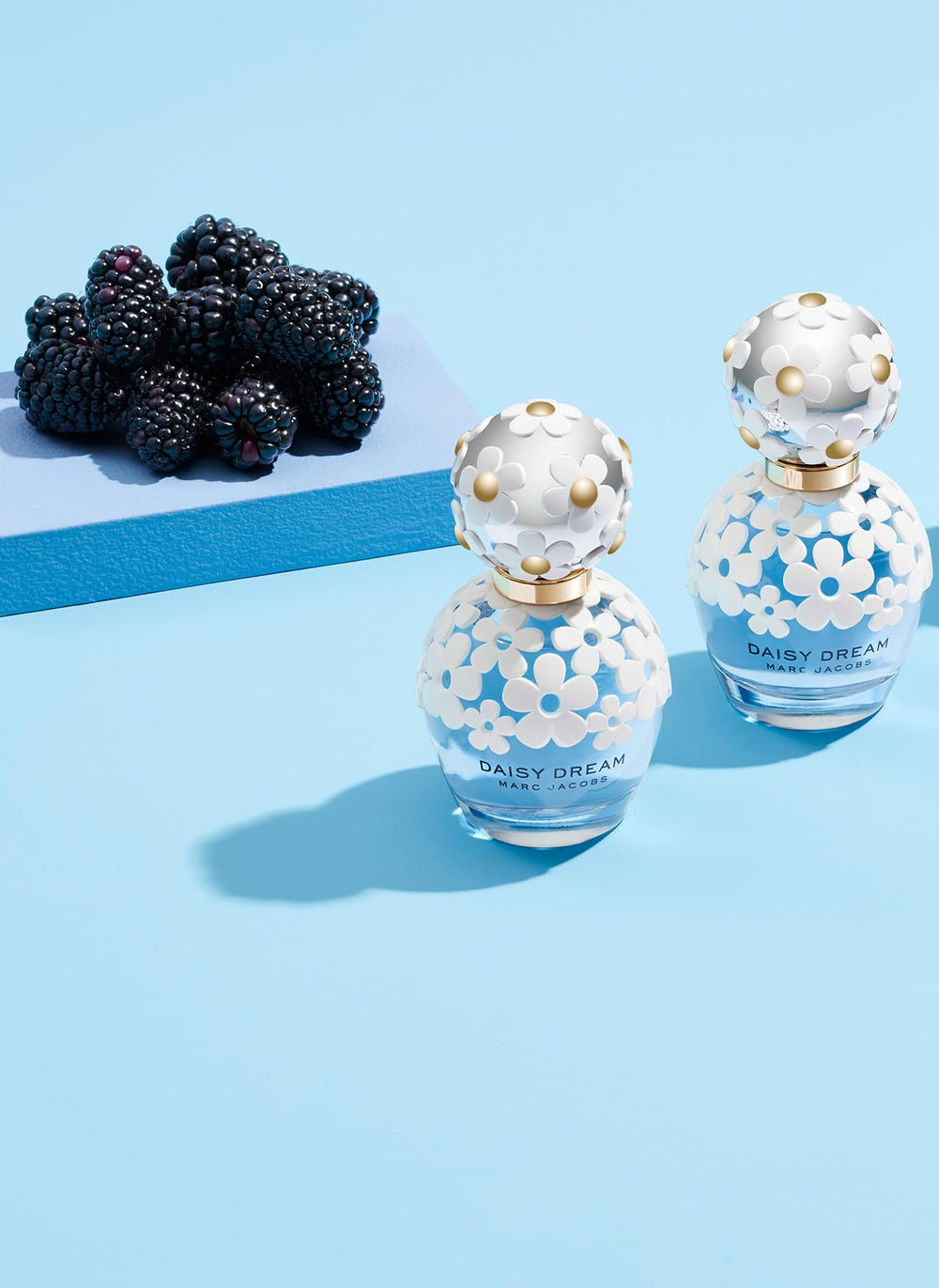 Marc Jacobs Daisy Dream next to a ruler for size comparison, 3.3 fl oz portability benefit