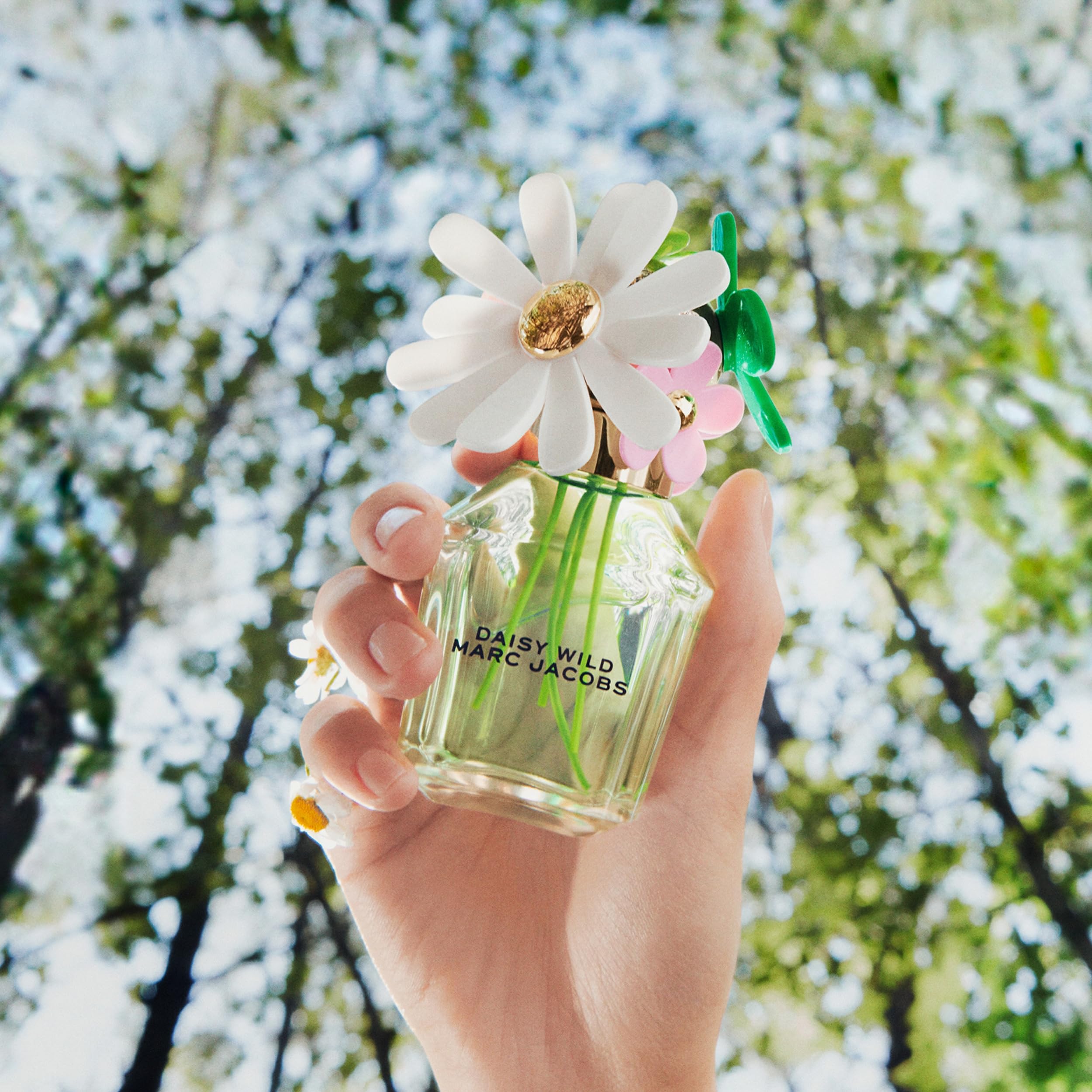 Marc Jacobs Daisy Wild in-use spray captured applying scent for confident freshness