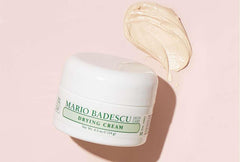 Mario Badescu drying cream next to hand for size and portability benefit