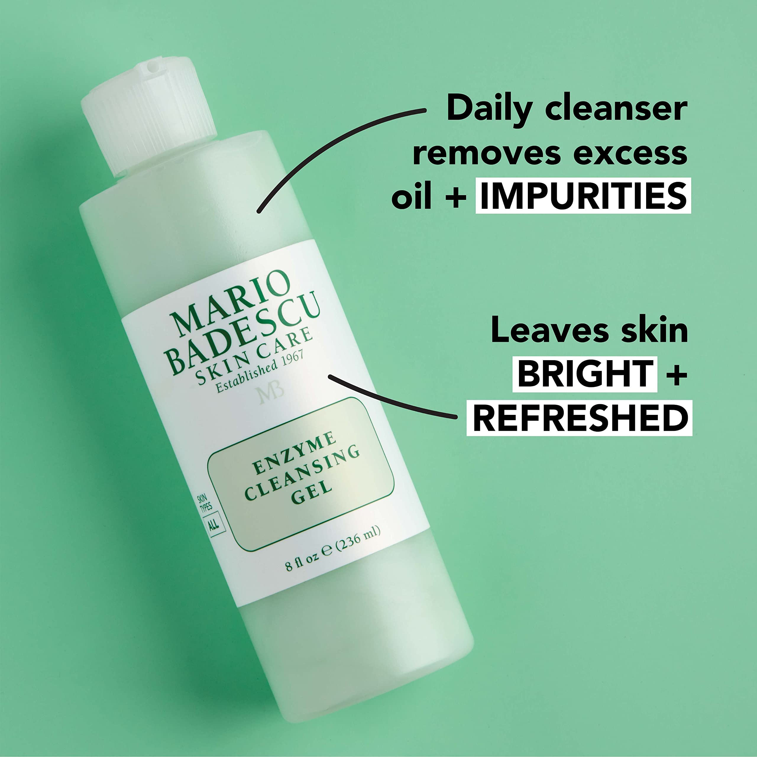 Papaya and grapefruit next to Mario Badescu product illustrating natural enzyme exfoliation