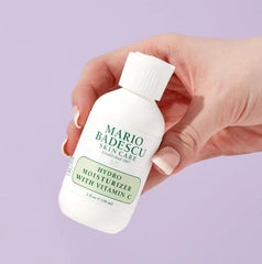 Mario Badescu moisturizer in hand for scale showing compact two-ounce convenience