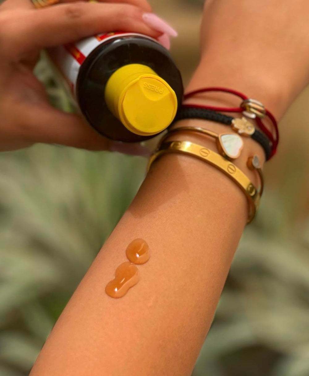 Application of Maui Island Secret on forearm demonstrating even coverage and fast tanning benefit