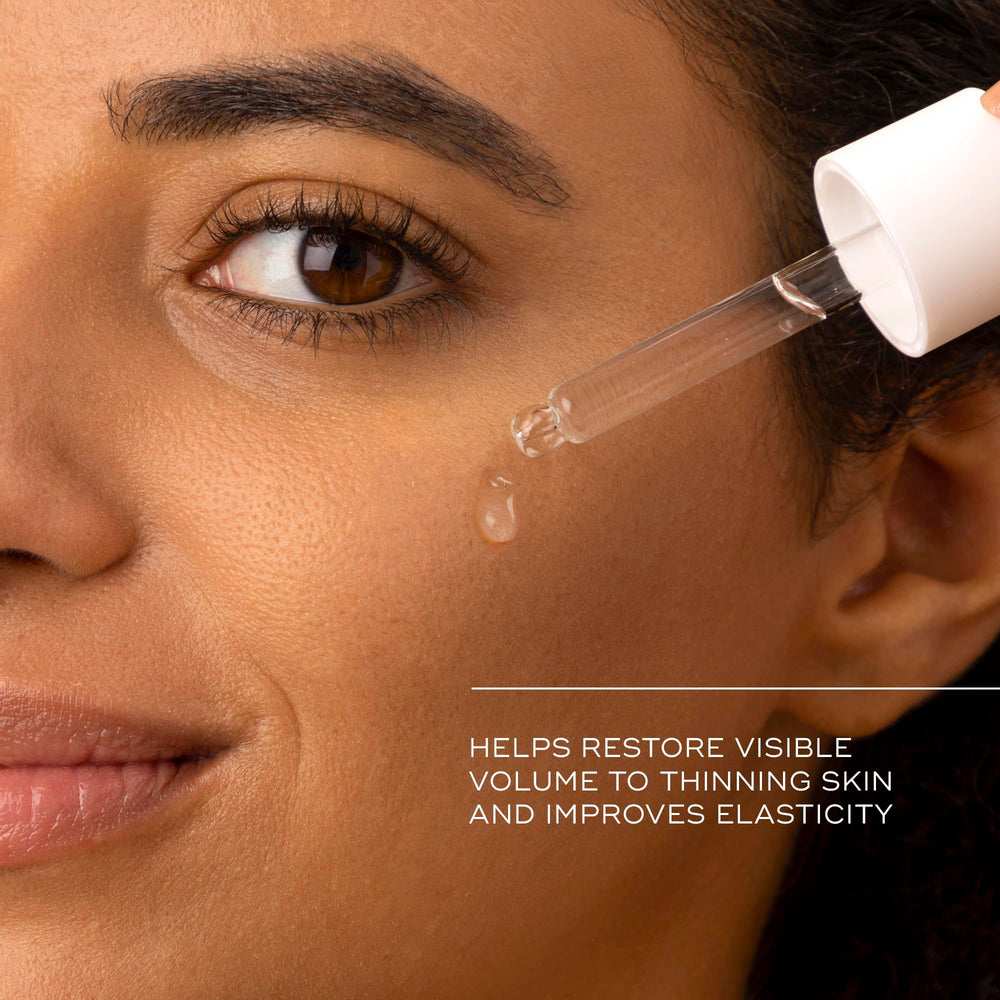 Medik8 Liquid Peptides in hand to show one‑ounce scale and travel‑friendly size