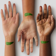Mehron stick applied to model cheek demonstrating rich green color for theatrical contrast