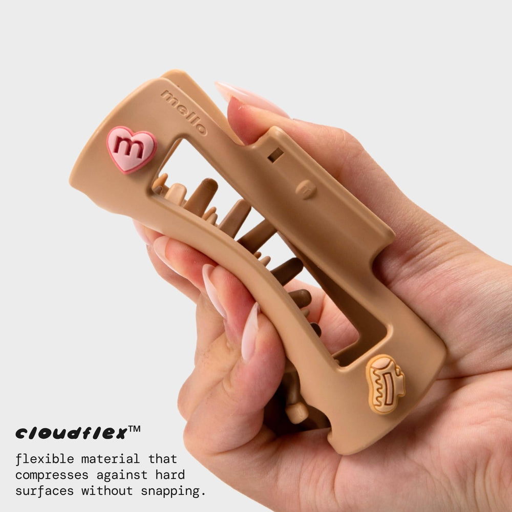 MELLO clip in hand for size comparison showing portability benefit