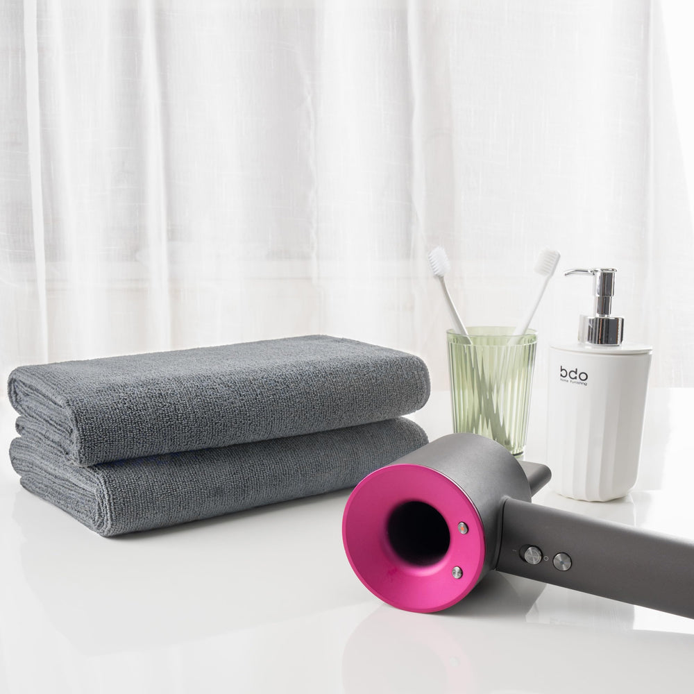 MICROFI towels folded beside ruler showing generous size and coverage advantage