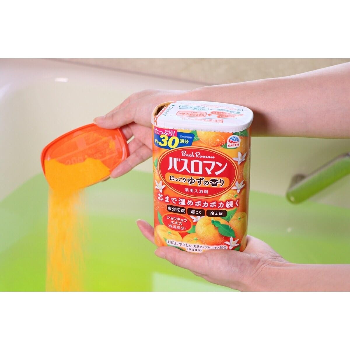 Migdla jar beside a hand to show 600g size and convenient portioning benefit