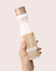 Milagros visible rosemary and ginger pieces in shampoo highlighting botanical formulation