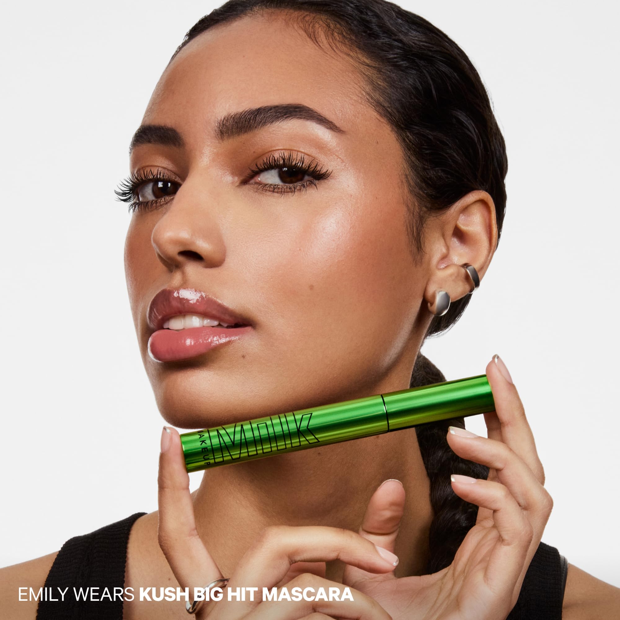 Milk Makeup next to ruler showing compact 0.28 oz size for travel convenience