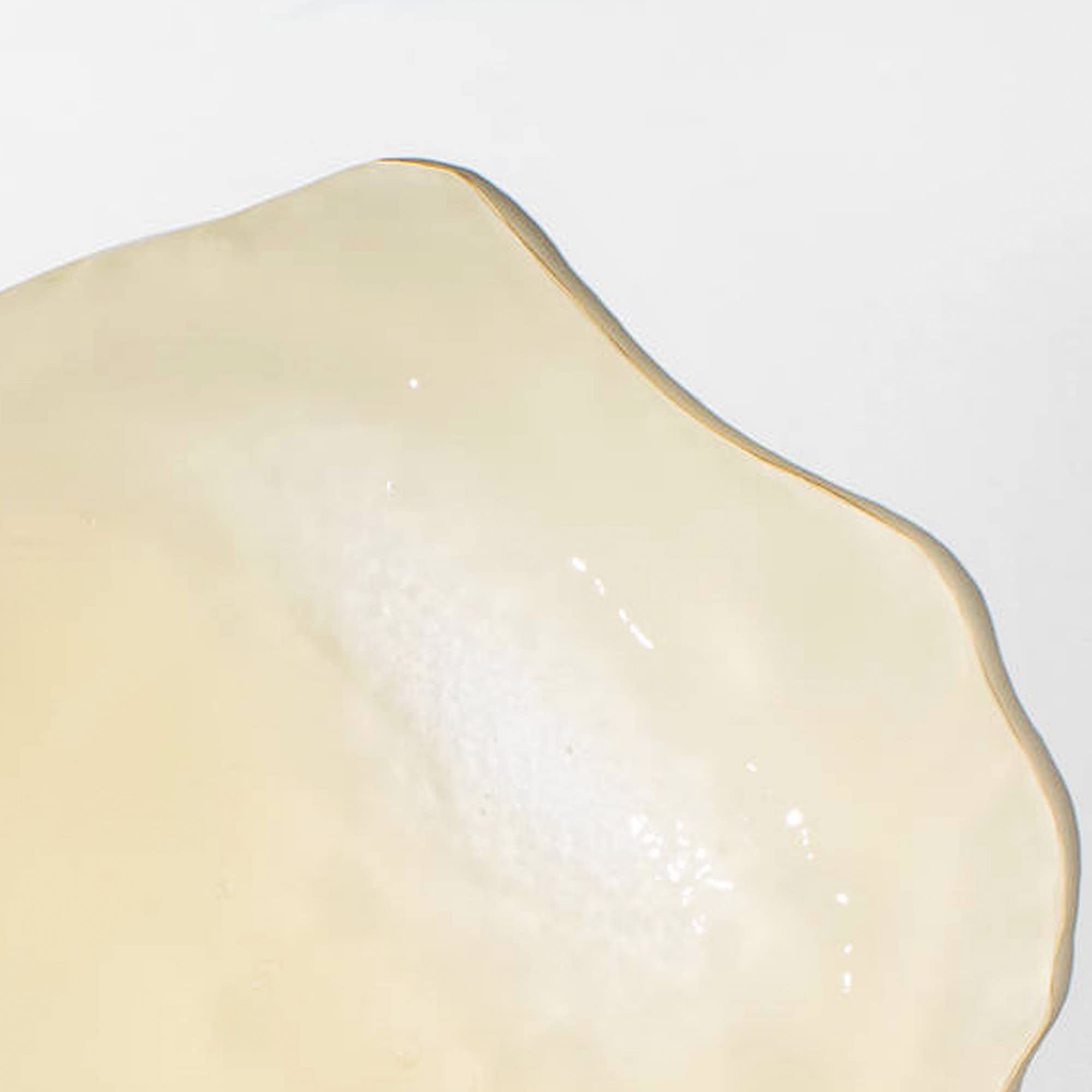 Mizani edge-control close-up demonstrating neat edges and shine benefit