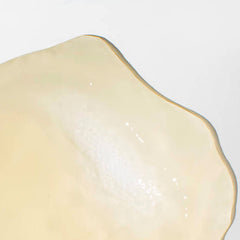 Mizani edge-control close-up demonstrating neat edges and shine benefit