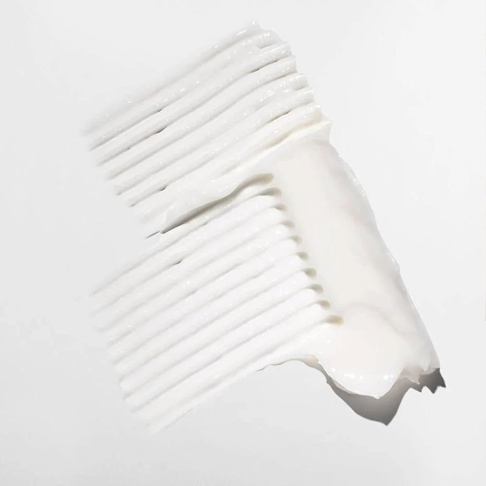 Mizani in-shower application on wet curls demonstrating quick absorption benefit