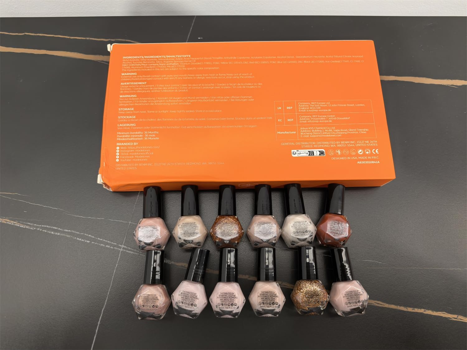 modelones bottles beside coin scale to show compact travel-friendly size