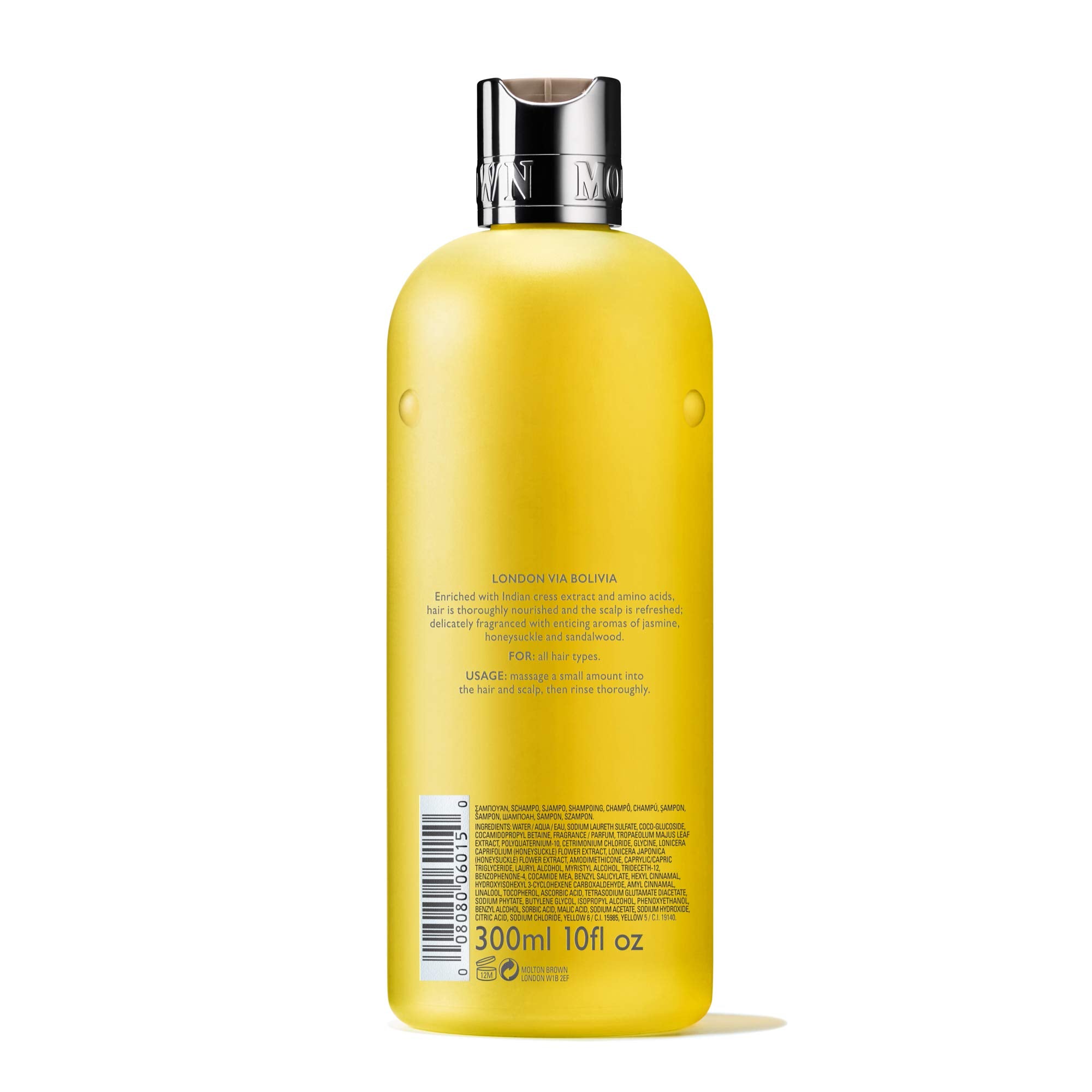 Molton Brown bottle in hand showing 10 fl. oz. size for scale and travel