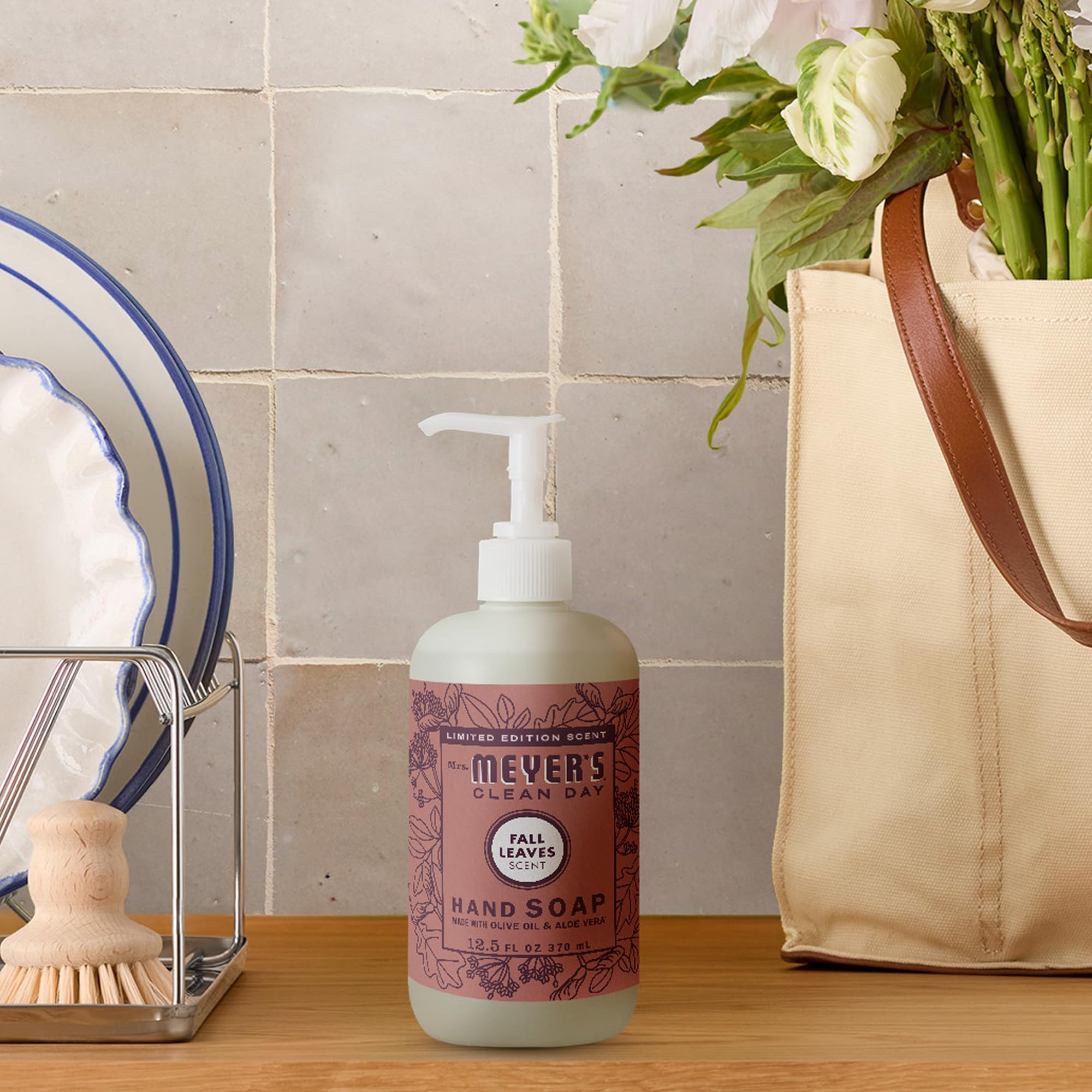 Mrs. MEYER'S bottle styled with autumn decor conveying seasonal ambiance and pleasant scent benefit