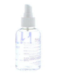 Hand applying Nairobi sheer shine to mid-lengths demonstrating fast absorption and smoothing