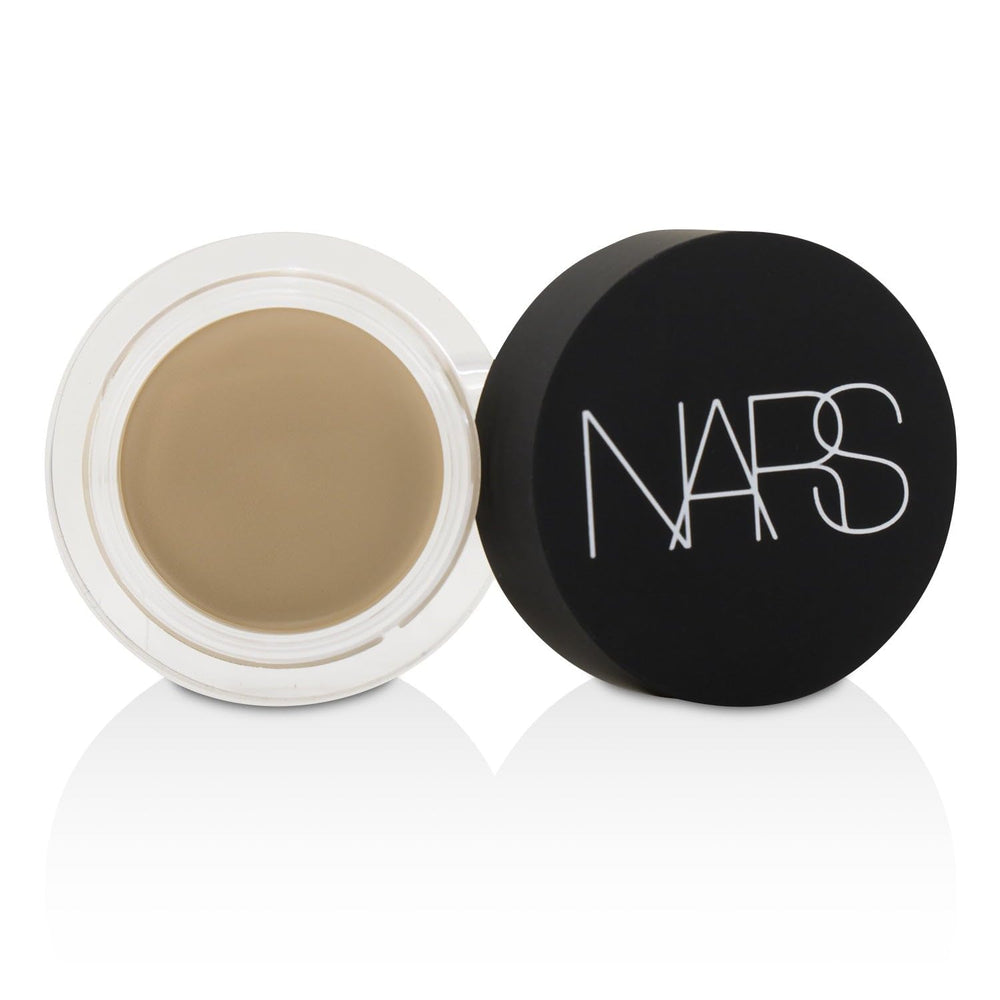 NARS concealer flatlay with other cosmetics illustrating versatile makeup pairing
