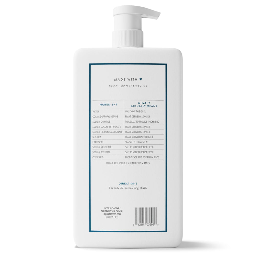 Visual of sea salt crystals and cedar wood near bottle, communicating fresh natural scent