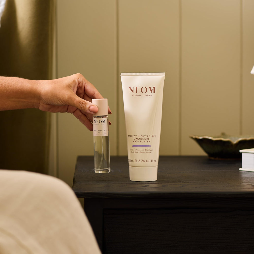 Neom body butter on bedside table in calming setting promoting relaxing pre-sleep ritual