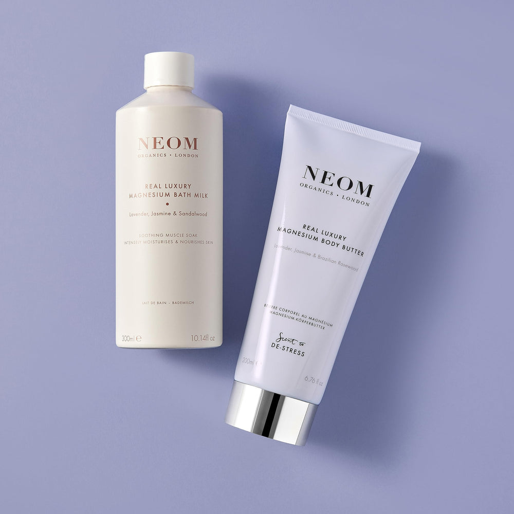 NEOM bottle next to a hand for scale to show convenient 300ml size