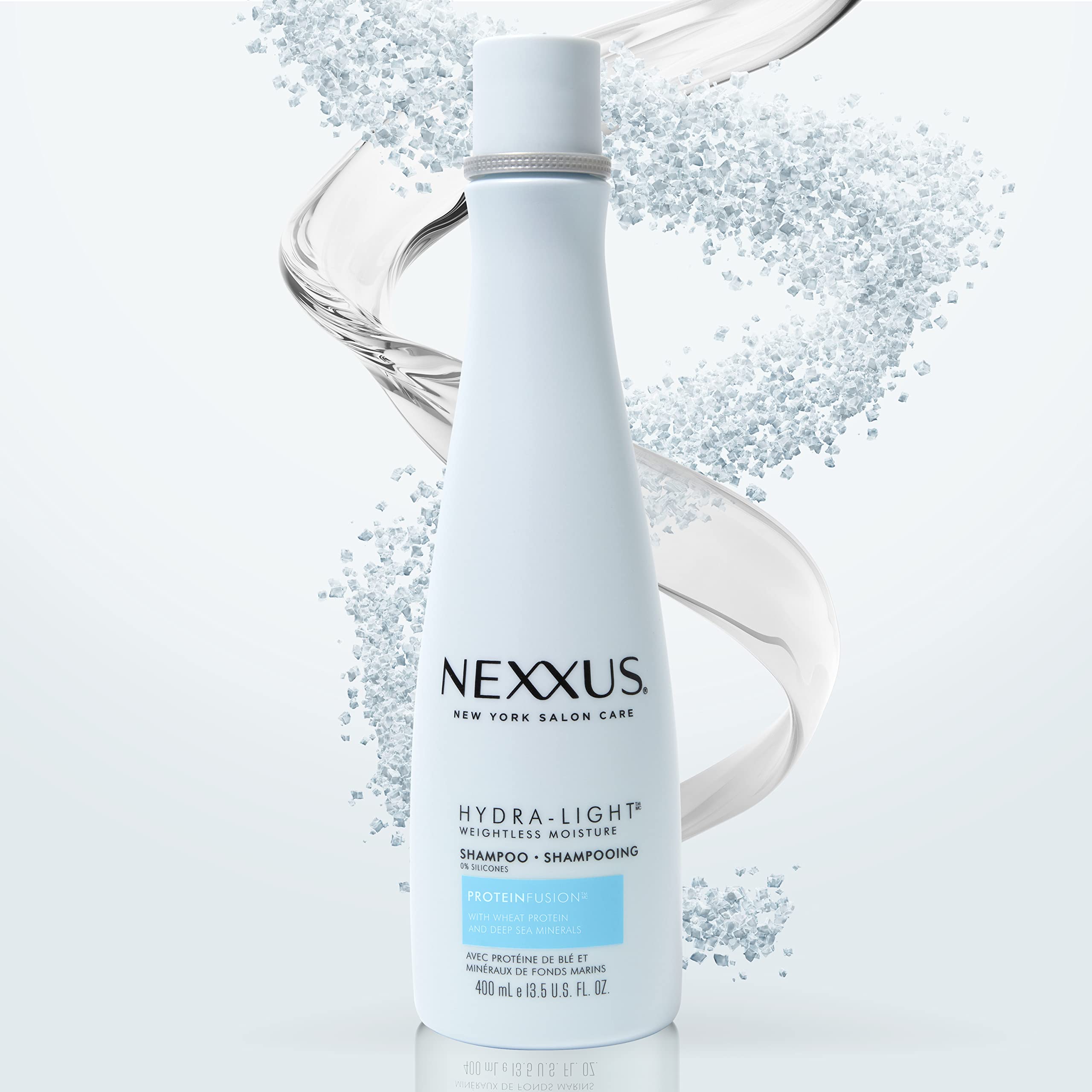 Nexxus hydra-light size comparison with hand to show bottle scale