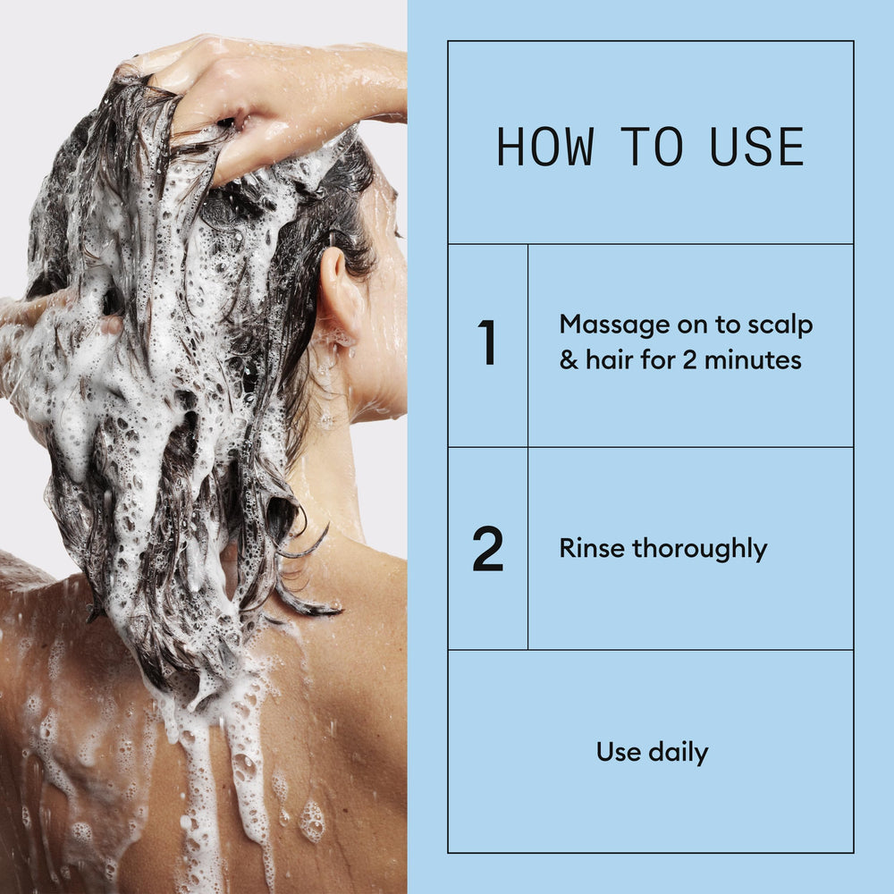 NIOXIN bottle in hand demonstrating size and daily-use convenience