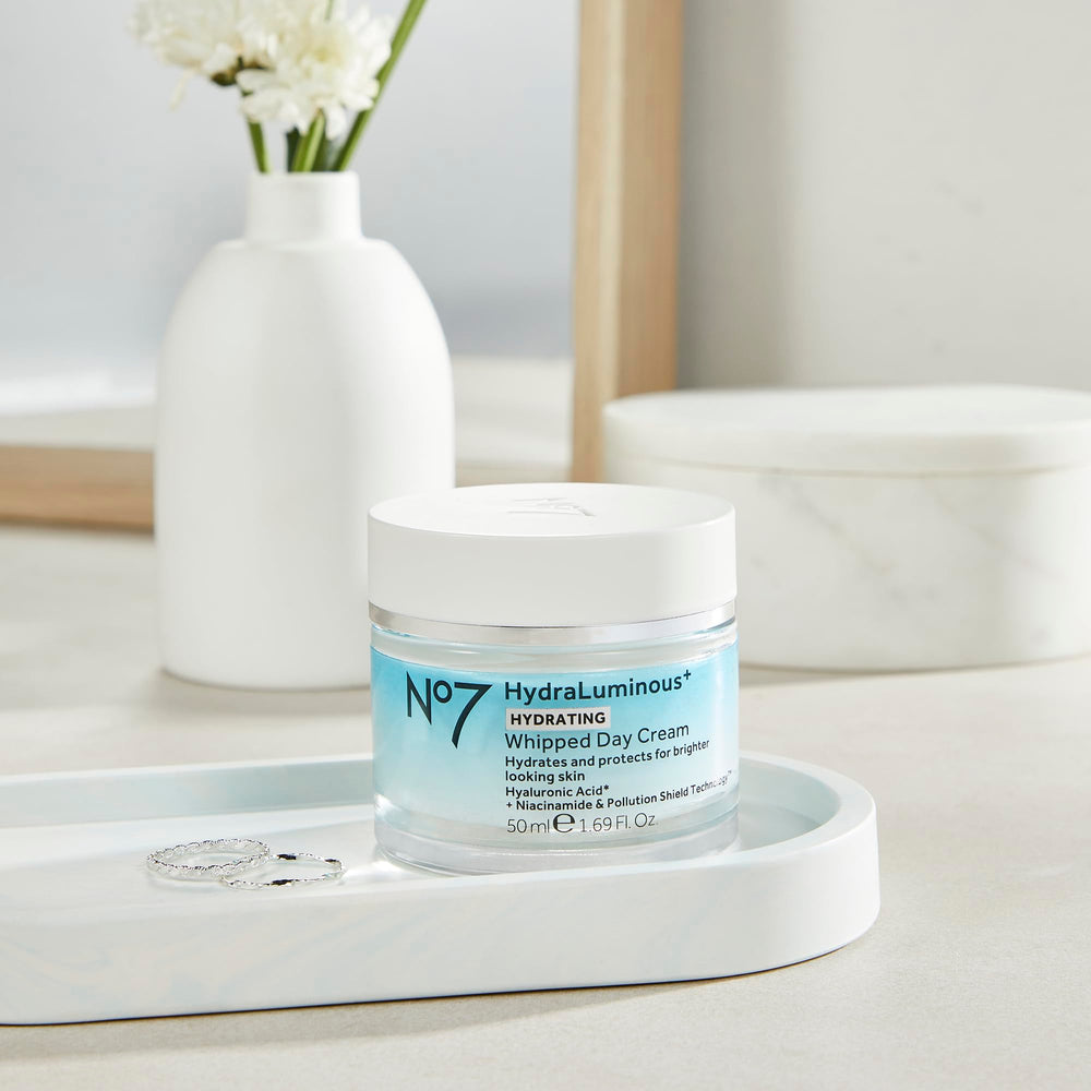 No7 hydraluminous+ next to ruler showing 1.69 fl oz size for travel-friendly convenience