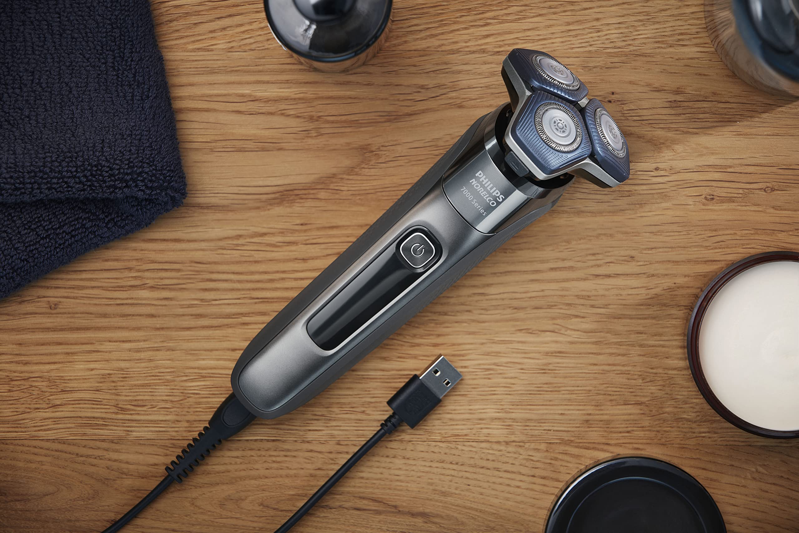Norelco 7200 accessories laid out with protective cap and cleaning brush