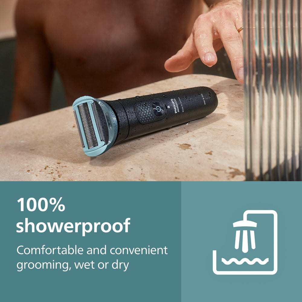 Philips Norelco held in hand for scale to show compact grooming size