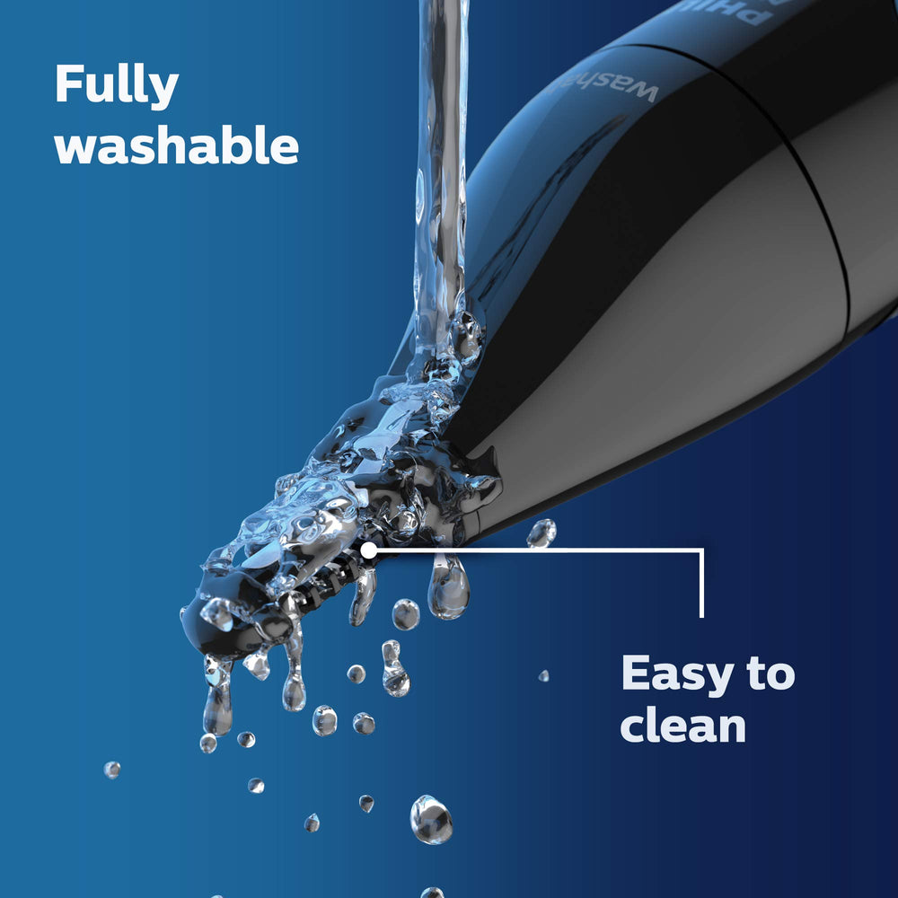 Norelco trimmer held in hand showing size and travel convenience
