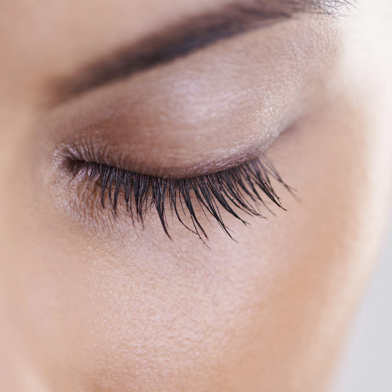 NutraLuxe Lash MD vial in hand showing 1.5ml size for travel
